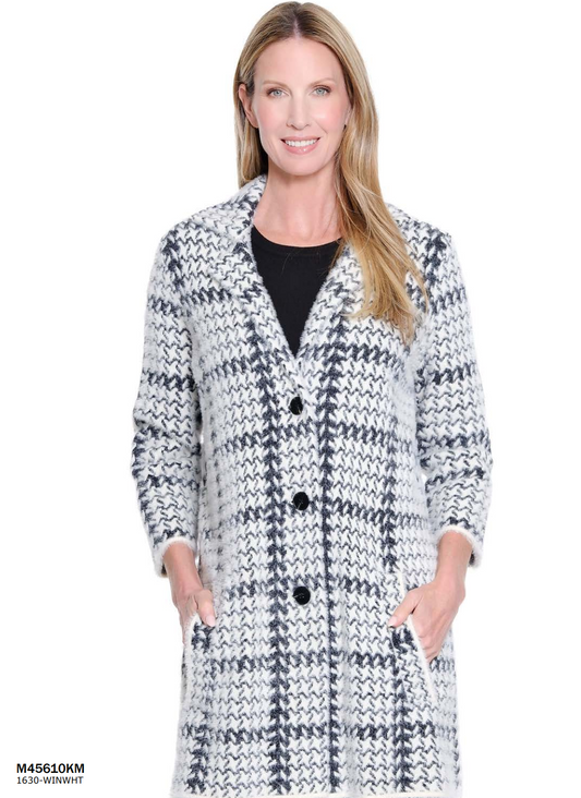 Woman wearing a black and white checkered coat on a white background